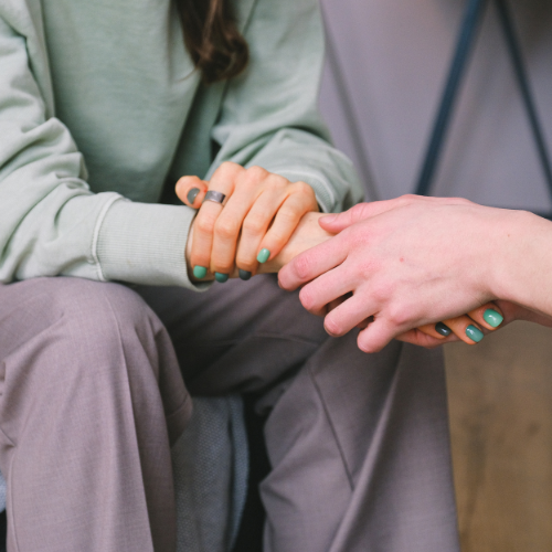 supporting women holding hands